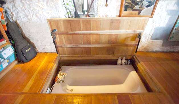 Hidden floor tub with latch door