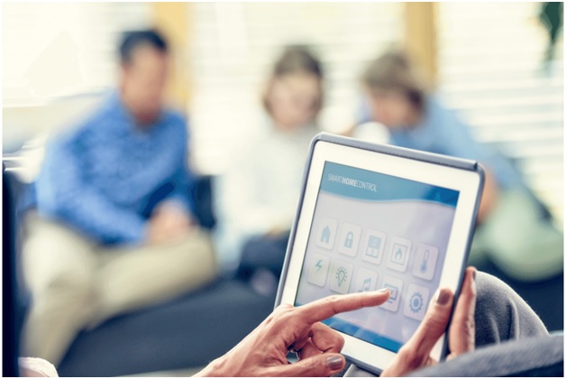 person using ipad to control their home lighting